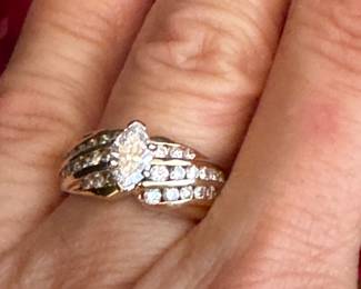 #31 - 1 carat center diamond Marquise cut with small round diamonds 3 rows on 14kt yellow gold. $2,500. 