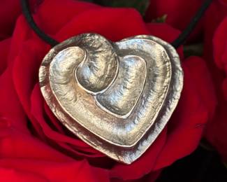 13. Yves St. Laurent silver tone heart pendant $220