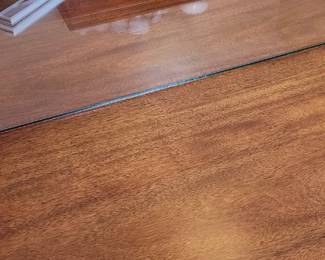 Trestle double drop leaf dining table with glass top and table pads and 6 upholstered drop-seat chairs