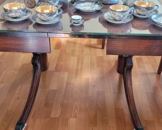 Trestle double drop leaf dining table with glass top and table pads and 6 upholstered drop-seat chairs