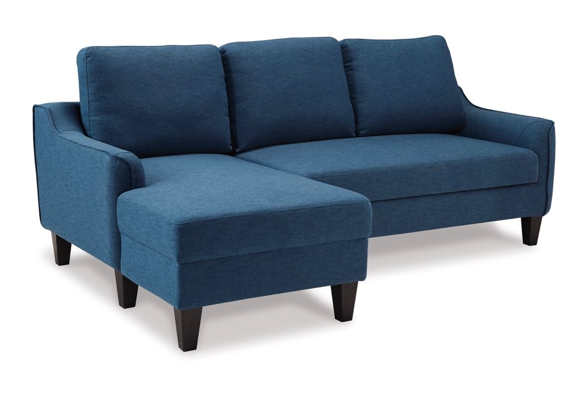 This awesome sofa has its original tag on it, and it unfolds to become a guest bed