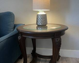Pretty table with glass inset. Also, there are multiple lamps available throughout this home.