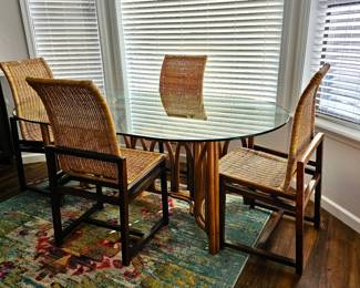 Glass top bamboo dining table with 4 chairs. Mid-century modern cane and walnut dining chairs. 