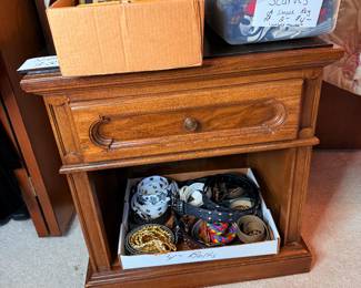 Belts, purses & scarfs on a night stand 