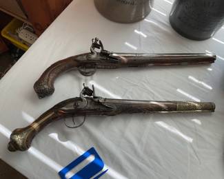 Two original vintage flintlock black powder pistols.