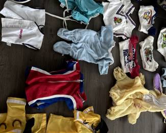 Multiple Vintage Snoopy Doll outfits and accessories.