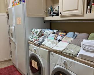Whirlpool washer and dryer and Kitchenaid side by side refrigerator/freezer. Cleaning Supplies and towels