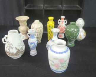 Lot # : 377 - Ten Japanese miniature porcelain vases with a display wood rack. 
