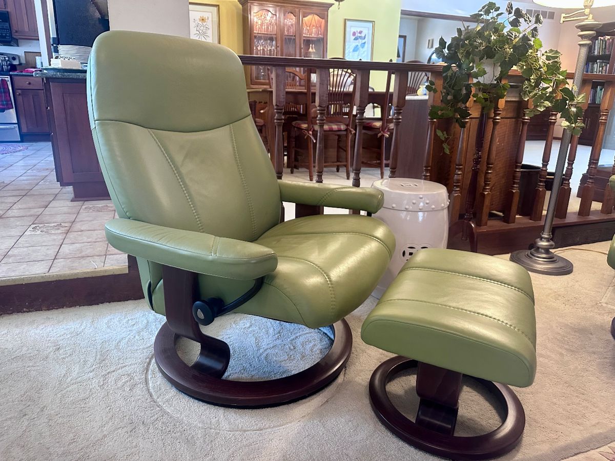 One of two Stressless (Norway) swivel recliners with footstools.