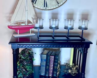 Unusual black shelf with cute decor.