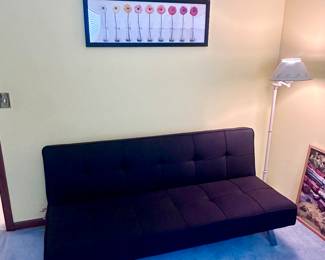 Modern black futon with chrome legs.