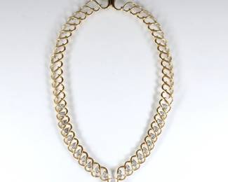 An 18k Gold and Diamond necklace custom made by Cary Stefani, Birmingham, MI.  Interlocking openwork necklace with twisted design, twenty-two pear cut Diamonds bezel set in White Gold, approx. 3.25 x 6 mm each, estimated 7 - 8 cttw, and a central glass simulated "diamond".  Incised "18k" and dated "1987".  59.2 grams total.  Original central Diamond replaced with glass simulated "diamond".  Approx. 16" long open.