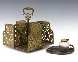 Two turn of the century German desk items.  Includes a rotating Cast Brass tabletop book stand with floral openwork design, and a cast Iron Lily Pad form ink stand with an Iridescent Art Glass inkwell.  Book stand marked "Germany" and "3999" at underside, ink stand marked "Geschutzt" at underside with "DRGM".  Wear to patina and some oxidation, book stand lacks one screw.  Up to 9 x 9 x 9 1/2" high overall.