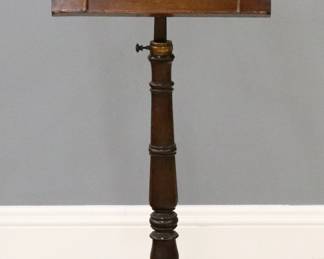 A 19th century English duet stand.  Mahogany construction with carved detail features an adjustable double sided music rack with Lyre design on a turned stem and tripod base.  Older refinishing with some wear, minor repair, lacks one rack support.  43" high.