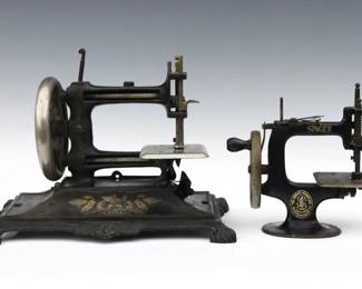 Two early 20th century miniature sewing machines.  Cast Iron bodies with hand-crank mechanisms, includes a Muller type machine and a Singer "Sewhandy" child's machine.  Wear and oxidation, Singer mechanism working but needs adjustment, Muller type with some damage.  Up to 11 x 7 x 8 1/2" high overall.  
