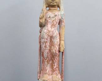 A large Chinese stone figure of Guan Yin.  Depicted standing with hand raised on a lotus base with polychrome finish.  Wear to finish, some chips to back of foot.  36 1/2" high.  
