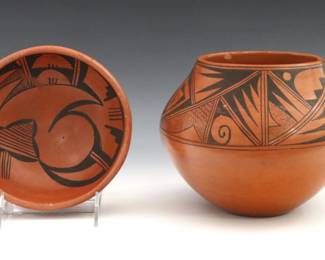 
Two 20th century Native American Earthenware vessels. Includes an olla and a bowl with Red glaze and Black geometric decoration. Both with faint illegible signatures at undersides. Larger with flakes to rim, both with some surface wear. Up to 7 1/2" diameter x 6 1/2" high.