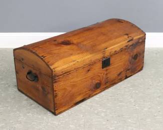 An early 19th century primitive Pine trunk.  Dome top design with Iron heart-form handles.  Older refinishing with minor wear, shrinkage, some replaced hardware.  33 x 16 1/4 x 14" high overall.
