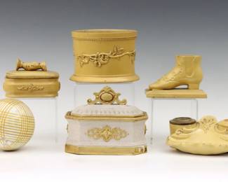 Six pieces of 19th to early 20th century Yellow Ware pottery.  Includes an Anton Tschinkel match strike box, a canister with foliate decoration, a shell form inkstand, a shoe form match holder with strike, a match box with strike and clasping hands, and a carpet ball with linear decoration.  Most with impressed initials or numerals.  Some wear and minor damage overall, inkstand lacks cover and has one replaced liner, cannister lacks lid.  Up to 4 1/2" high.  
