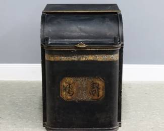 A turn of the century Toleware floor tea bin.  Tin box with domed cover and stenciled decoration with Chinese characters.  Surface wear and some denting.  19 x 22 x 27" high overall.