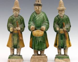 Three Chinese Tang style Terracotta tomb figures.  Depicted as standing musicians with Sancai glaze.  Two shorter with repairs at necks, some flakes to bases.  Up to 8 1/4" high.  
