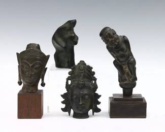 Four small Bronze and wooden sculptures.  Includes a Nepali style Bronze bodhisattva head, a Thai Ayutthaya style Bronze Buddha head on a wooden plinth, an Indonesian figural carved wood Kris knife handle on a wooden plinth, and an abstract Bronze sculpture of two figures embracing.  Some wear to surface and patina, Thai head with damage at top.  Up to 6 1/4" high.  
