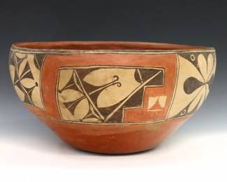 An early 20th century Zia Pueblo Earthenware dough bowl.  Large tapered form with polychrome geometric decoration.  Some wear to decoration and burst air bubbles.  17" diameter x 8 3/4" high overall. 

