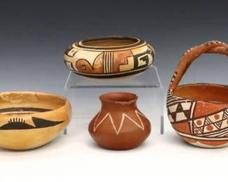 Four pieces of 20th century Native American Earthenware.  Includes a basket with twisted handle, two low bowls and a small pot with geometric polychrome decoration.  Two bowls and the basket with repairs, small pot with chips to rim, some where to decoration overall.  Up to 6 1/4" high.  

