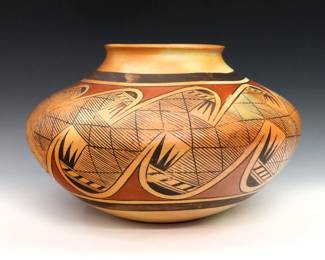 Fannie Nampeyo, Hopi-Tewa, 1900-1987.  A mid 20th century Earthenware olla with bulbous form with geometric polychrome decoration.  Signed "Fannie Nampeyo" at underside.  Small chip to rim, some wear to decoration.  Approx. 12 1/2" diameter x 7 3/4" high overall. 
