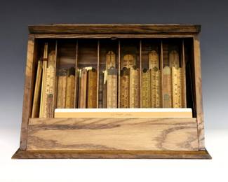 A 20th century Lufkin countertop display case and a collection of specialty rules and tools.  Includes an Oak Lufkin "Spring Joint Rules" display case with hinged front and rear storage, over forty Boxwood folding rules, dress maker's measures, tailor's squares, log rules, shoe measures and other pieces by various makers including Lufkin, Beichner Bros., and J. Rabone & Sons, with three empty Lufkin boxes.  Wear and minor damage.  Lufkin case is 17 3/4 x 12 1/4 x 11" high overall, rules/tools up to 96" open.  
