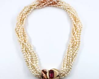 A multi-strand Pearl necklace with 14k Gold clasp and Rhodalite Garnet, custom made by Yanke Designs, Traverse City, MI.  Features ten strands of freshwater Peals averaging approx. 5 mm, with gradient Blush tones and a 14k Yellow and Rose Gold clasp with oval cut prong set Rhodalite Garnet approx. 8.5 x 14.25 mm.  Marked "14k" and "Yanke Designs".  82.6 grams total.  Gold with minor surface wear.  17" long open. 