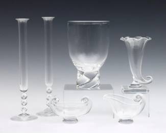 Six pieces of 20th century Steuben Crystal tableware.  Includes a pair of tall slender vases, a creamer and open sugar, a pedestal vase, and a cornucopia vase.  Each signed "Steuben".  Some surface wear.  Up to 12" high.
