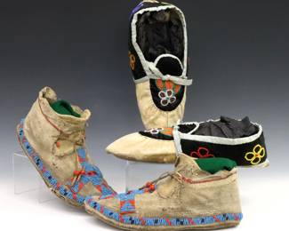 Two pairs of 20th century Native American beaded hide moccasins.  Includes a pair of earlier moccasins with cross design (possibly Cheyenne), and a pair of later Ojibwe moccasins with floral design.  Wear and some damage.  Up to 11" long.  
