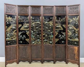 A 19th century Chinese Coromandel screen.  Molded Rosewood frames presented in six panels decorated with hand-carved vine and floral decoration on upper and lower panels and Black Lacquer center panels with hand painted Gold landscapes and carved Jade and hardstone applied detail with waterfowl and foliage, further decorated verso with hand-painted Gold landscape designs depicting mountain villages along a river on Black lacquer panels.  Cleaned original finish with some wear, craquelure, some shrinkage to carved panels. Each panel is 17 3/4 x 84 3/4" high, approx. 108 x 84 3/4" high overall.