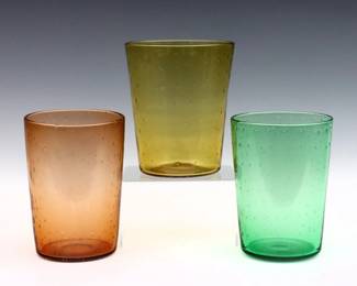 Three early 20th century Steuben Art Glass vases.  Tapered cylindrical forms with controlled bubble decoration in Pomona Green, Amber and Pink.  Green vase with acid etched "Steuben" mark, other two attributed.  Some surface wear.  Each approx. 7" high.