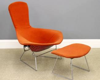 A Mid Century Modern Harry Bertoia for Knoll "Bird" lounge chair and ottoman.  Chrome coated Steel frame with shaped lattice seat and back, Red/Orange upholstery and matching ottoman.  Upholstery with fading and some staining.  Chair is approx. 38 x 34 x 39" high overall, ottoman is 24 x 17 x 15" high overall.