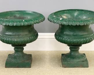 A pair of late 19th century American Cast Iron garden urns.  Re-painted Green with some wear.  Each 19" diameter x 18" high overall.