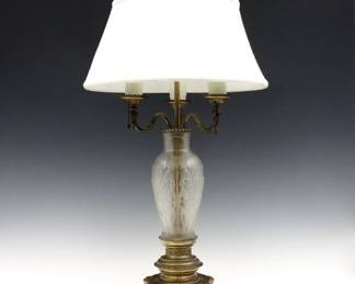An early 20th century Steuben style table lamp.  Three light design featuring a baluster form vase with acid etched foliate decoration, on Bronze mounts with paw feet.  Includes a later fabric shade.  Wear to original Gilded finish, minor distortion to arms.  28 1/4" high.  

