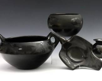 Four pieces of 20th century Native American Earthenware, likely Santa Clara and San Ildefonso Pueblo.  Includes a two handled vessel by Pablita Tafoya Chavarria, a bowl, a bird form trinket dish and a small vase by Abigail Lopez.  Vessel signed "Pablita Santa Clara" and vase "Abigail Lopez" at undersides.  Vessel body with crack, bowl with hairline, some surface wear and crazing.  Up to 10" long and 5 1/4" high.  
