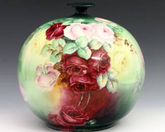 A turn of the century Lenox Belleek porcelain vase.  Round form with flared rim and hand-painted Rose decoration.  Printed Lenox "Belleek" mark with palette.  Repaired neck, some surface wear.  Approx. 9" diameter and 10" high overall.  
