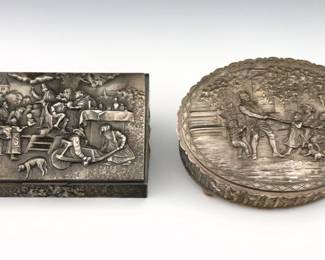 Two mid 20th century Continental Silverplate boxes.  Both with repousse genre scenes, includes an Italian jewelry casket attributed to Guido Galbiati, and a Dutch cigar box after "The Quack" by Jan Steen.  Italian box with partial "GG" and Bee mark.  Some surface wear.  Each 9" long. 
