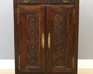 A late 19th century country French side cupboard.  Oak construction with hand carved decoration features a long drawer over two paneled doors and a shaped lower apron on simple block feet.  Original Brass hardware.  Old dark finish with some wear, shrinkage and minor damage.  39 x 126 1/2 x 55 1/2" high overall.