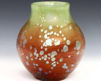A turn of the century Loetz Cytisus Art Glass vase.  Bulbous form in mottled May Green to Orange with pulled linear decoration.  Minor surface wear.  6 1/2" high.  
