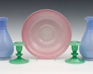 Five pieces of early 20th century Art Glass.  Includes a Steuben Rosaline pink low bowl, a pair of Steuben Jade Green low candlesticks, and a pair of Powder Blue ewers.   Some surface wear.  Up to 10" diameter and 8 1/2" high. 
