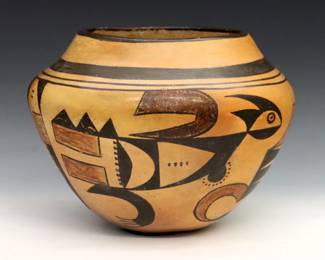 A mid 20th century Native American Earthenware jar, likely Hopi.  Bulbous form and geometric polychrome decoration.  Some wear to decoration.  9 1/4" diameter x 7 1/4" high overall. 
