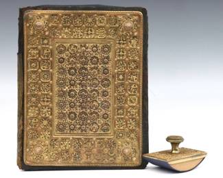 Two early 20th century Copper filigree ink blotters.  Include a bound leather case with blotter pads and a rocking blotter with Gilded Copper mounts and filigree design.  Wear and damage overall, particularly to leather.  Up to 11 1/2" long. 
