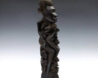 An African Makonde style wooden "Tree of Life" carving.  Hand-carved with many ancestral figures.  Some shrinkage and very minor damage.  20 1/2" high.  