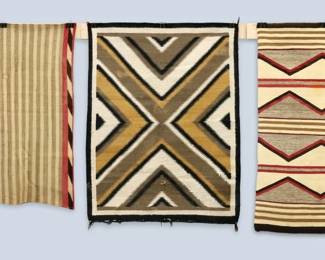 Three 20th century Navajo Regional weavings.  Multi-color geometric designs on Tan and Grey fields.  Some wear and staining and damage, two with repairs.  Up to 3.1 x 4.1' high overall. 