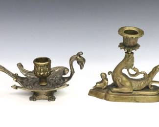 Two Neoclassical chambersticks.  Includes a 19th century Bronze chamberstick with Griffin design, and a later Gilded metal chamberstick with Peacock design.  Some wear to patina.  Up to 8 1/4" long and 5" high.  
