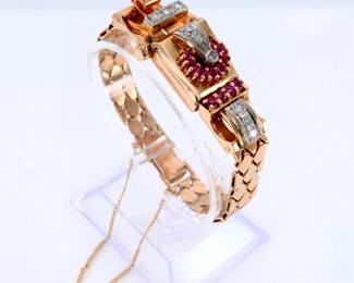 A vintage 14k Rose Gold ladies bracelet wristwatch with Rubies and Diamonds.  Features a 14k Rose Gold case with round cut prong set Rubies, each approx. 2 mm, and Diamonds accents, each approx. 2.25 mm, on a bracelet with flat diamond form links.  17j, manual wind Swiss movement, hinged button press cover reveals a painted metal dial with Arabic numerals marked "Geneva".  Marked "14k".  40.4 grams total.  Minor surface wear, back of case with slight denting, winds, sets and running when cataloged.  6 1/2" interior circumference.